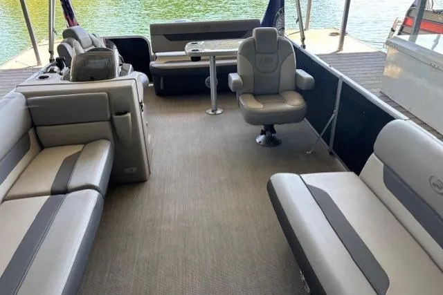 Slide: The Image of 2022 Princecraft Sportfisher 23-2S RL pontoon boat interior with spacious seating and table. - 8
