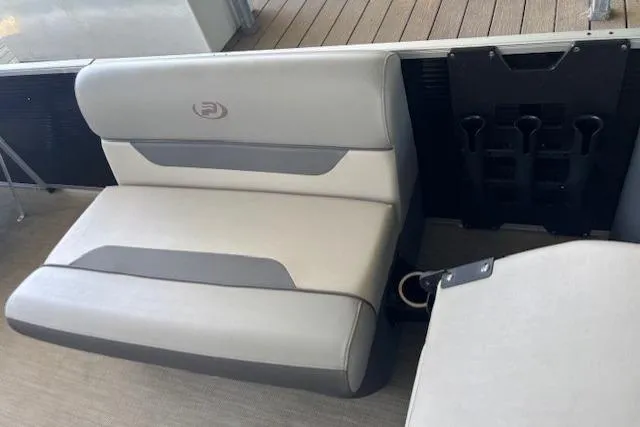 Slide: The Image of 2022 Princecraft Sportfisher 23-2S RL boat interior with cushioned seating and rod holders. - 9