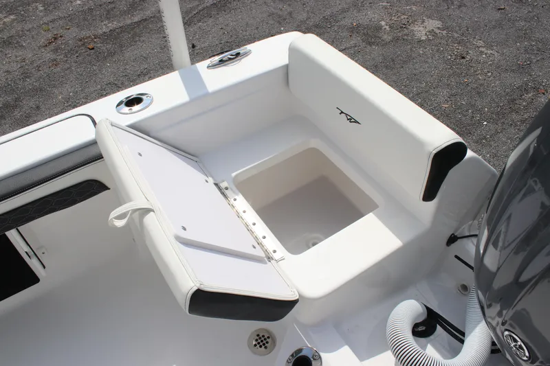 Slide: The Image of 2026 Tidewater 198 CC Adventure boat seat with storage compartment open. - 11