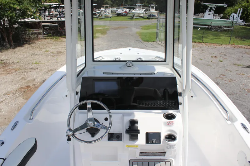 Slide: The Image of 2026 Tidewater 198 CC Adventure boat console with steering wheel and controls. - 13