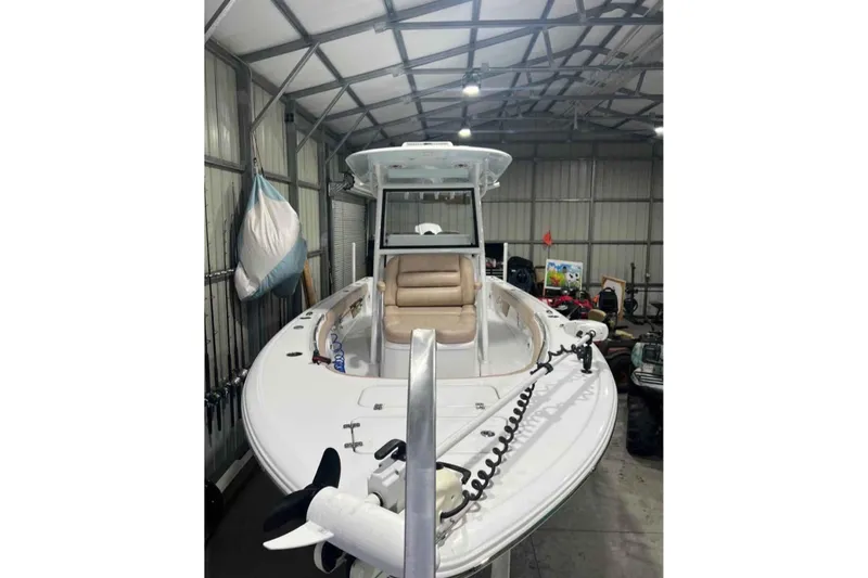 Slide: The Image of 2020 Sportsman Masters 267OE Bay Boat in a metal storage shed. - 2