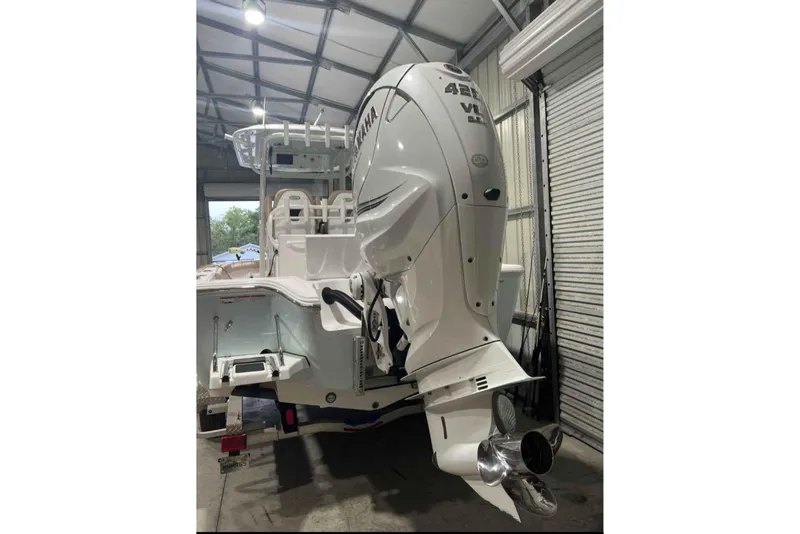 Slide: The Image of 2020 Sportsman Masters 267OE Bay Boat with Yamaha outboard engine in a garage. - 3
