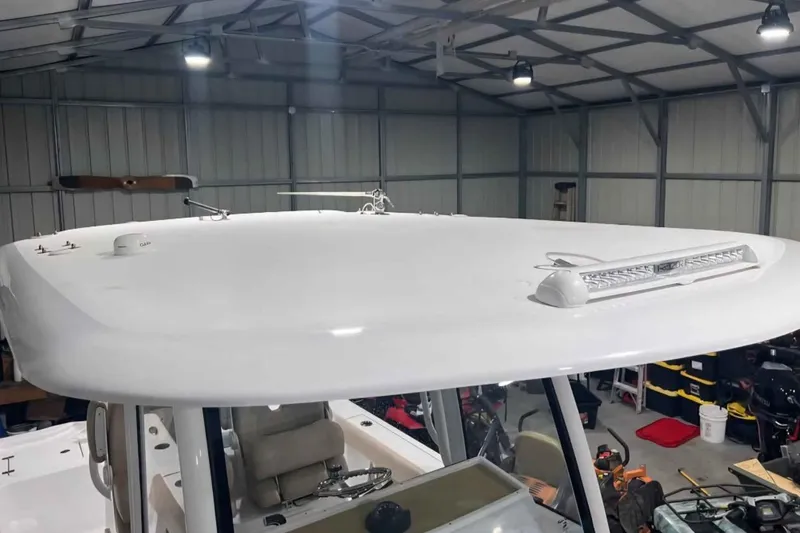 Slide: The Image of 2020 Sportsman Masters 267OE Bay Boat in a well-lit garage. - 4