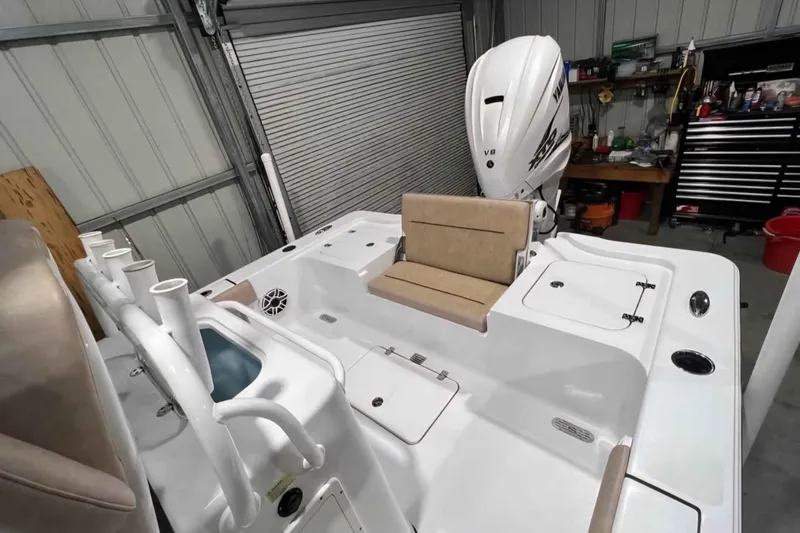 Slide: The Image of 2020 Sportsman Masters 267OE Bay Boat interior with seating and storage in a garage. - 7