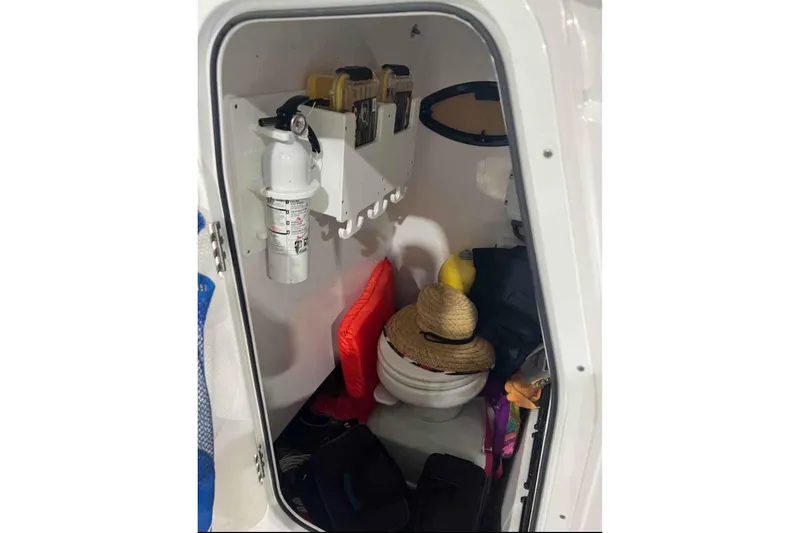 Slide: The Image of Interior of 2020 Sportsman Masters 267OE Bay Boat with storage and safety equipment. - 8