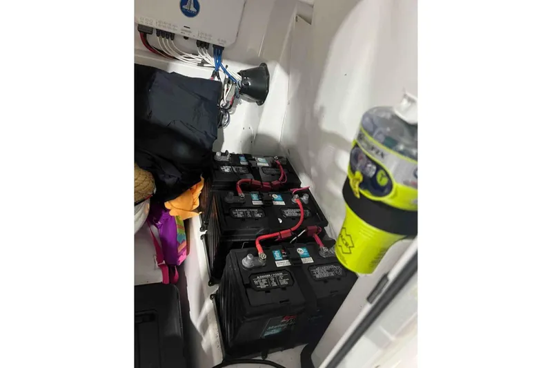 Slide: The Image of Battery compartment of a 2020 Sportsman Masters 267OE Bay Boat with wiring and accessories. - 9
