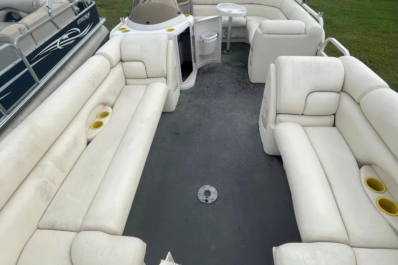 Slide: The Image of 2006 Starcraft Elite 226 pontoon boat interior with white seating and cup holders. - 5