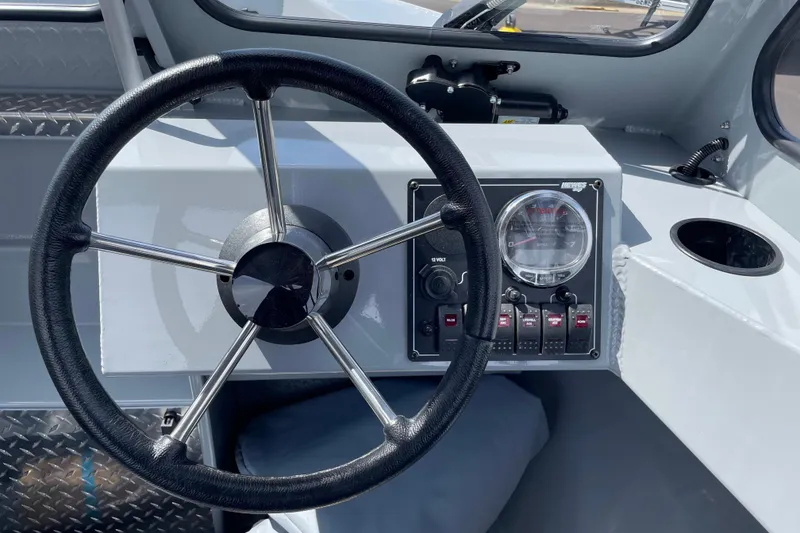 Slide: The Image of Steering wheel and dashboard of 2026 Hewescraft 180 Sportsman boat. - 12