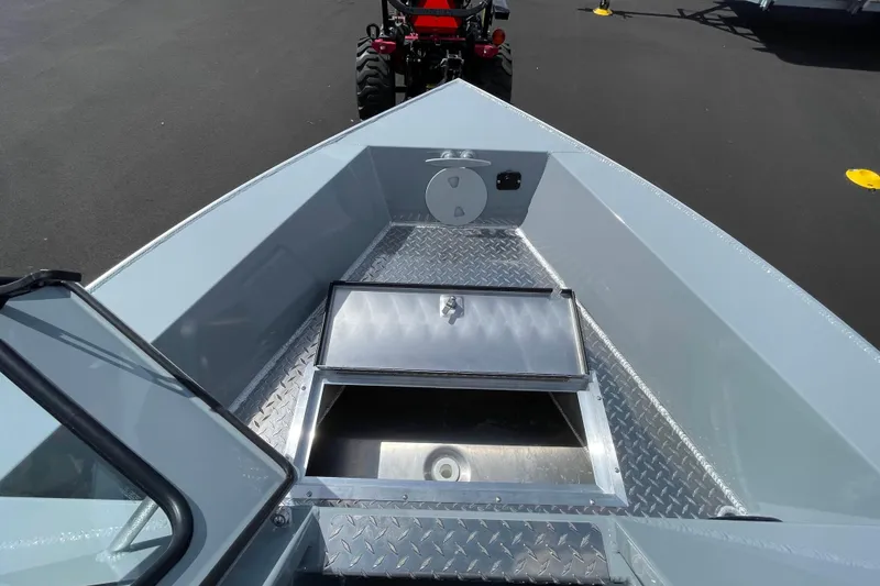 Slide: The Image of 2026 Hewescraft 180 Sportsman boat interior with storage compartment, diamond plate flooring. - 15