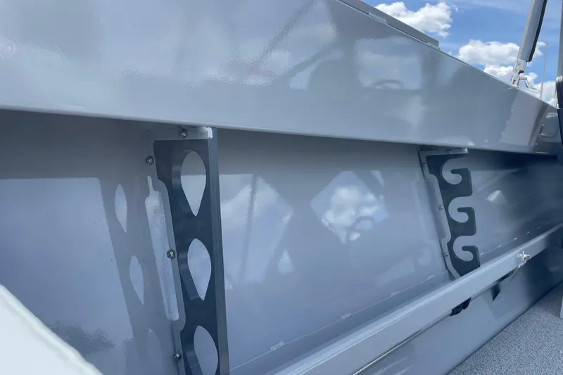 Slide: The Image of 2026 Hewescraft 180 Sportsman interior detail with metal brackets and blue sky background. - 16