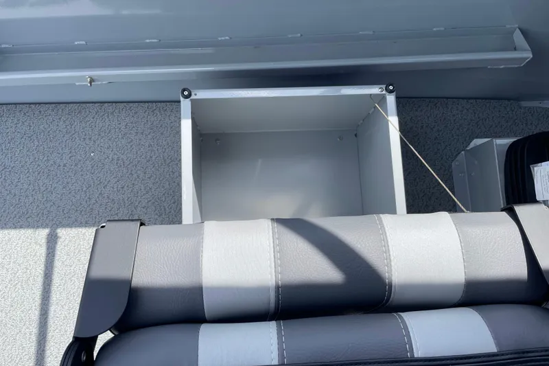 Slide: The Image of 2026 Hewescraft 180 Sportsman interior with storage compartment and gray seating. - 18