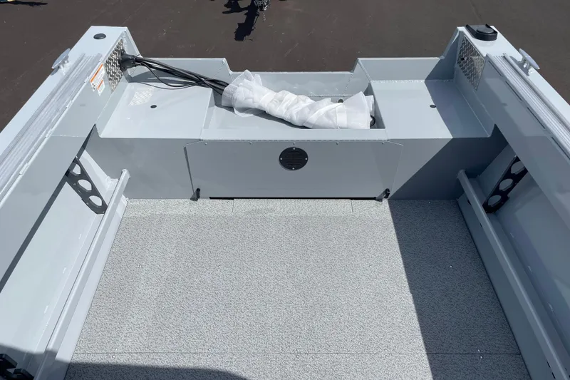 Slide: The Image of 2026 Hewescraft 180 Sportsman boat interior with storage compartment and wiring. - 7