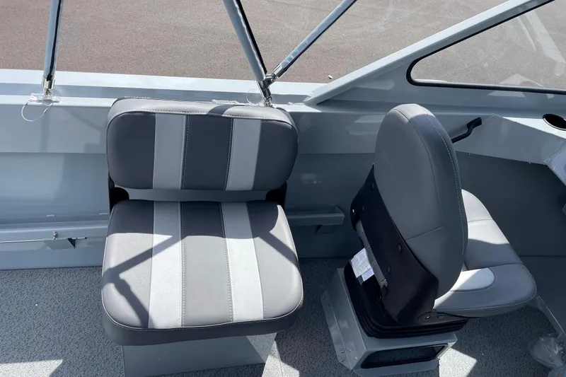 Slide: The Image of 2026 Hewescraft 180 Sportsman boat interior with gray seating and modern design. - 9
