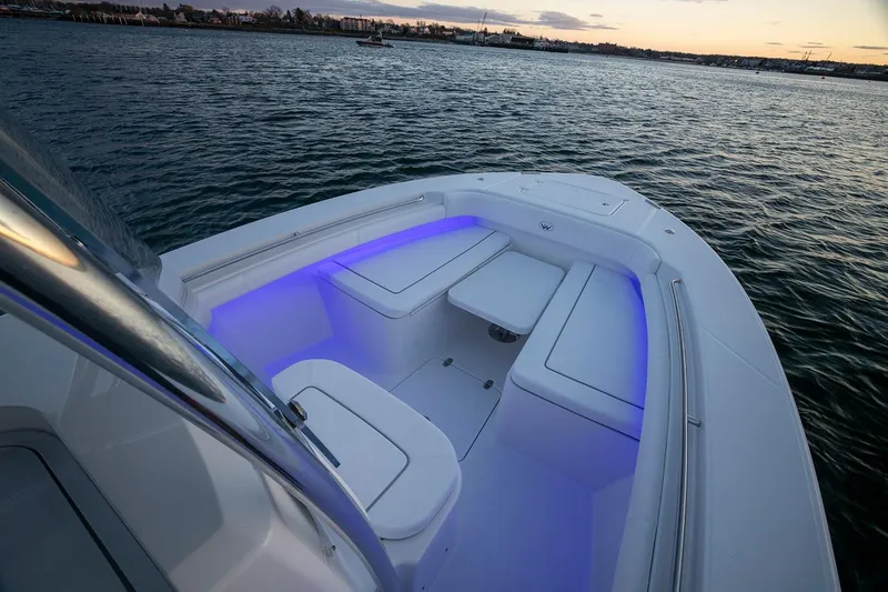 Slide: The Image of 2026 Southport 27 FE boat with illuminated seating at sunset on the water. - 3