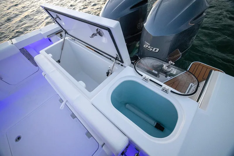Slide: The Image of 2026 Southport 27 FE boat with open storage compartments and dual outboard engines. - 7