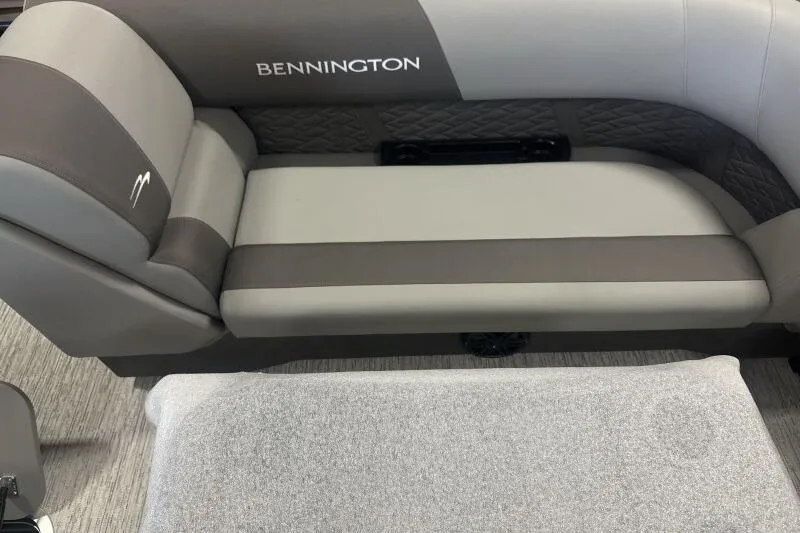 Slide: The Image of 2026 Bennington 22 SSR boat interior with gray and brown seating. - 12