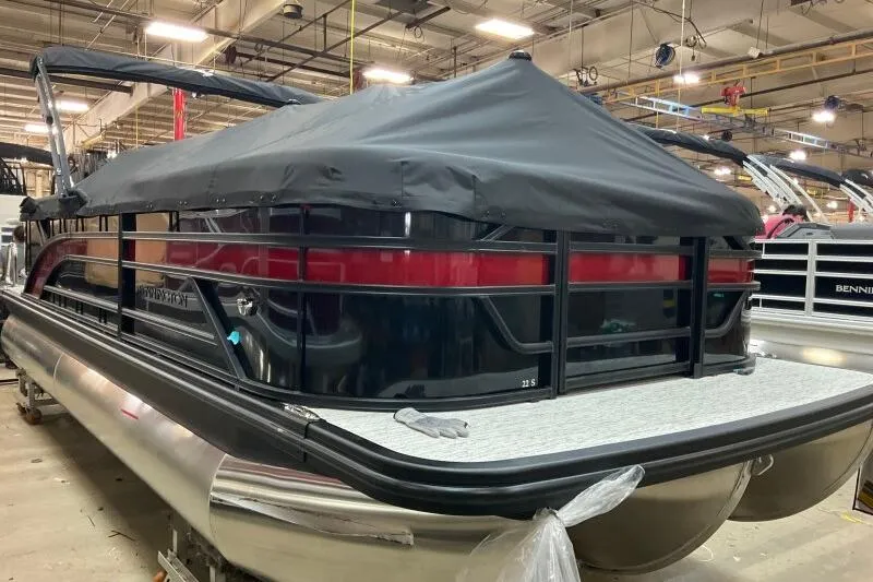 Slide: The Image of 2026 Bennington 22 SSR pontoon boat with cover in a factory setting. - 13