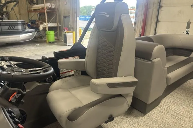 Slide: The Image of 2026 Bennington 22 SSR boat interior with luxurious captain's chair and steering wheel. - 9
