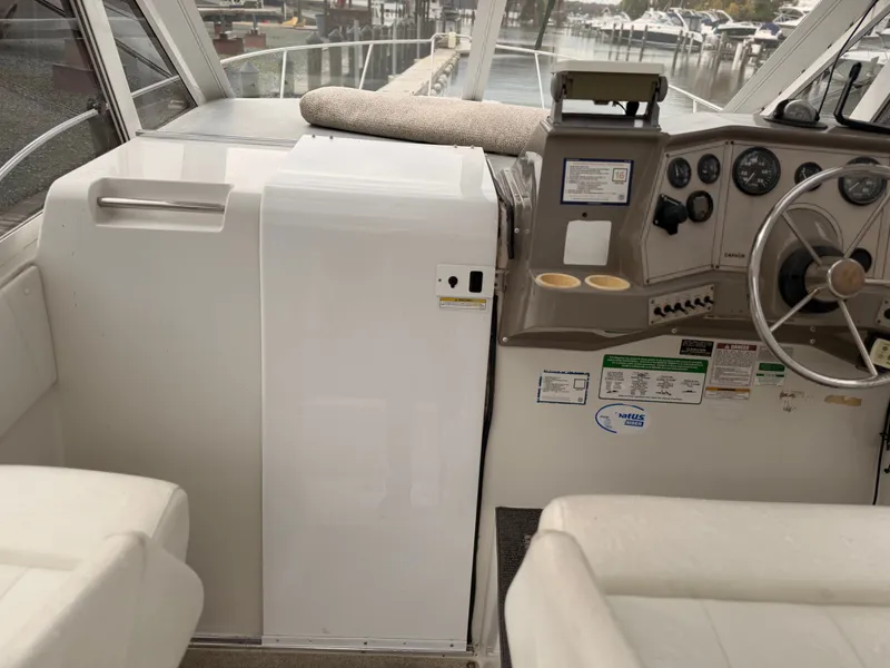 Slide: The Image of 1998 Carver Express Special Edition boat interior with steering wheel and control panel. - 14