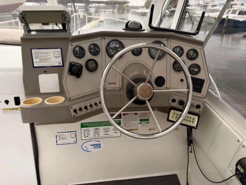 Slide: The Image of 1998 Carver Express Special Edition boat dashboard with steering wheel and gauges. - 15