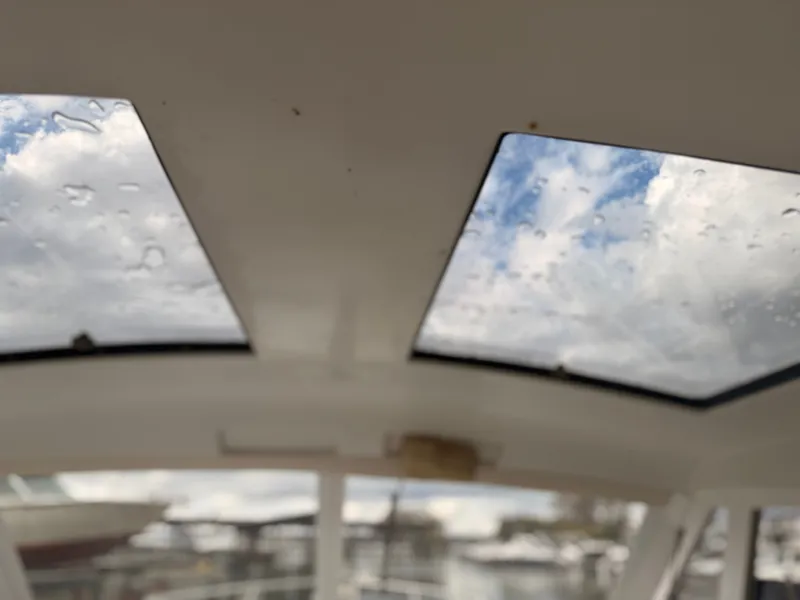 Slide: The Image of Sunroof view from 1998 Carver Express Special Edition, showcasing cloudy sky and raindrops. - 16