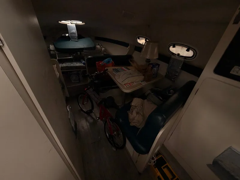 Slide: The Image of Interior of a 1998 Carver Express Special Edition boat with seating and various items. - 19