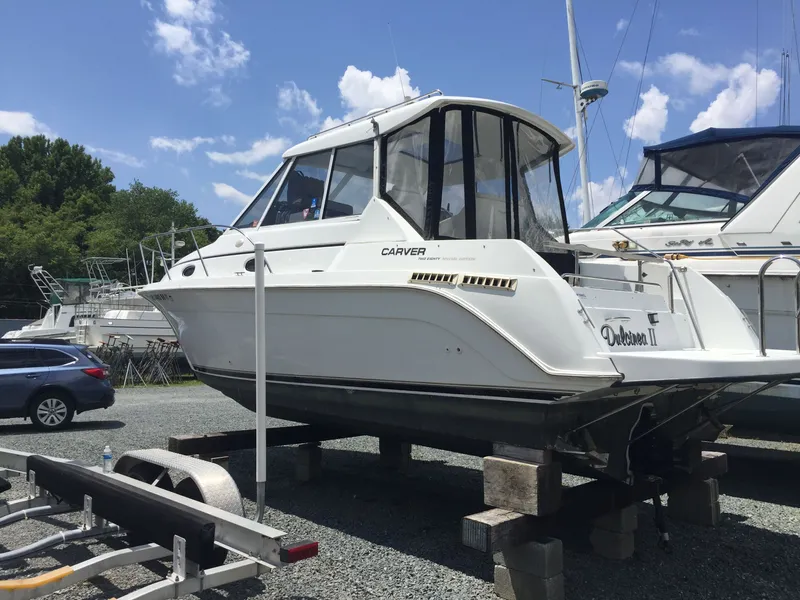 Slide: The Image of 1998 Carver Express Special Edition boat docked at marina under cloudy sky. - 4