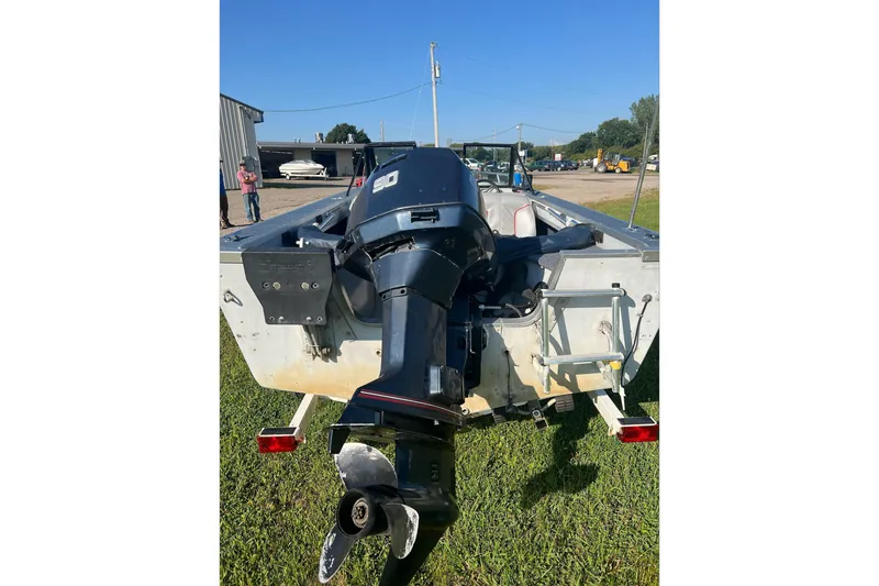 Slide: The Image of 1987 Blue Fin Sportsman boat with outboard motor on grassy area. - 6