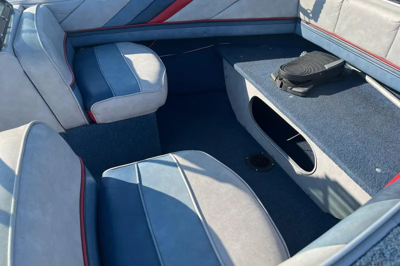 Slide: The Image of 1987 Blue Fin Sportsman boat interior with blue and red upholstery. - 8