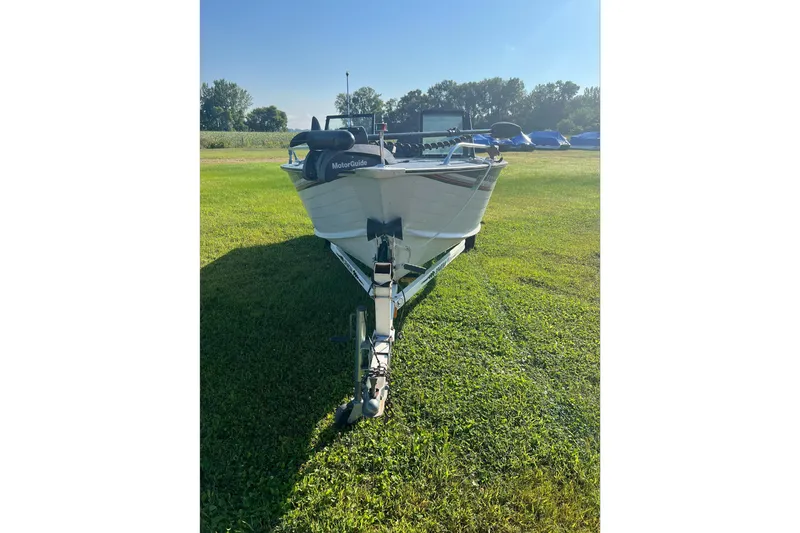 Slide: The Image of 1987 Blue Fin Sportsman boat on trailer in sunny grassy field. - 9