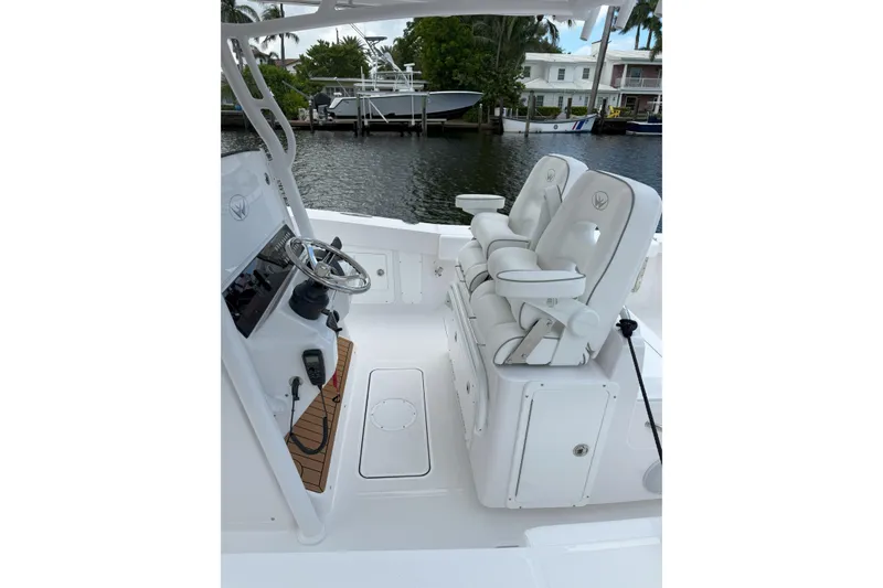 Slide: The Image of 2026 Southport 30 FE boat interior with dual white captain's chairs and steering console. - 10