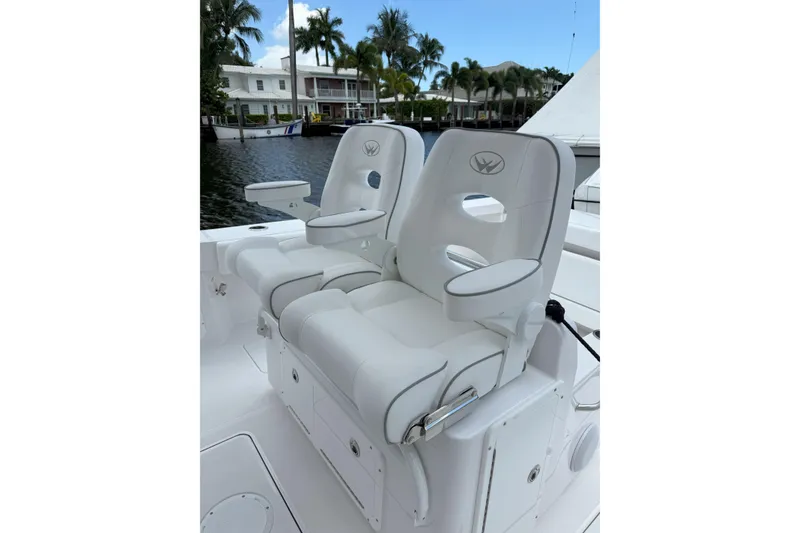 Slide: The Image of Luxury seating on 2026 Southport 30 FE boat, featuring plush white upholstery and armrests. - 11