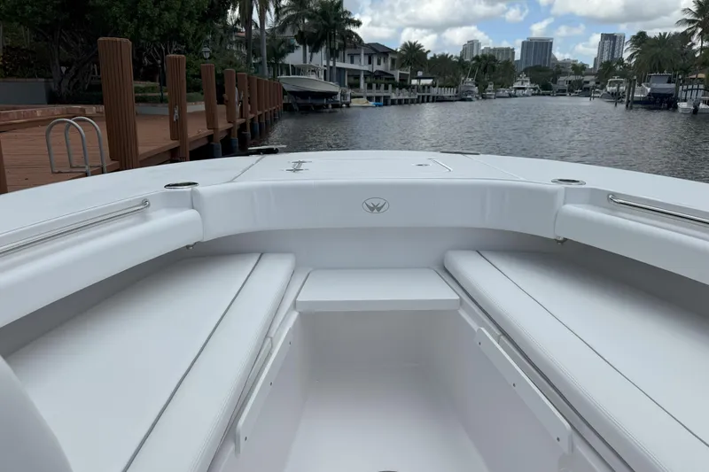 Slide: The Image of 2026 Southport 30 FE boat interior with white seating, dockside view, and waterfront backdrop. - 17