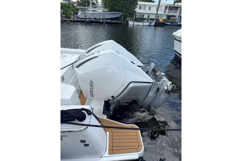 Slide: The Image of 2026 Southport 30 FE boat with dual Mercury outboard engines docked by the water. - 2