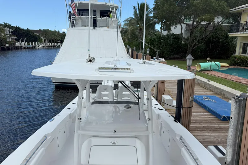 Slide: The Image of 2026 Southport 30 FE boat docked by a canal with lush surroundings. - 20