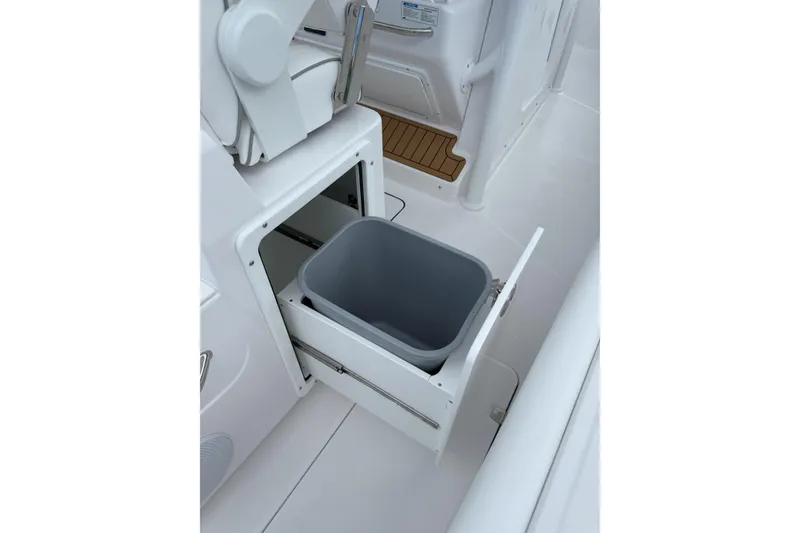 Slide: The Image of 2026 Southport 30 FE boat with built-in storage compartment and trash bin. - 25