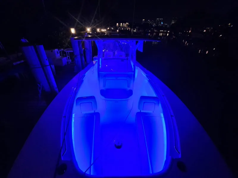 Slide: The Image of 2024 Southport 30 FE boat illuminated with blue LED lights at night. - 27