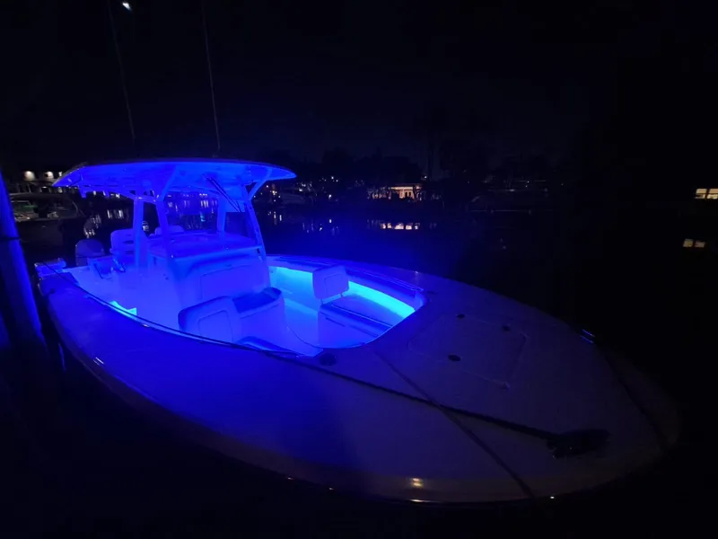 Slide: The Image of 2024 Southport 30 FE boat illuminated with blue LED lights at night. - 28