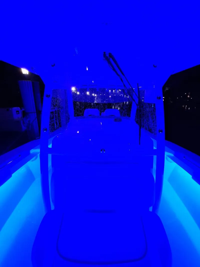 Slide: The Image of 2024 Southport 30 FE boat illuminated with blue LED lights at night. - 33