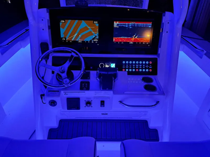 Slide: The Image of 2024 Southport 30 FE boat dashboard with illuminated controls and navigation screens. - 35