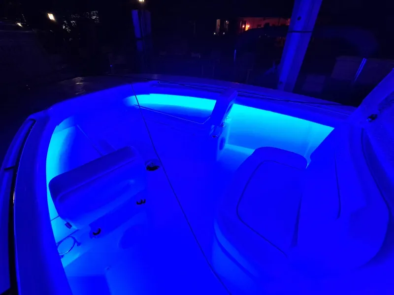 Slide: The Image of 2024 Southport 30 FE boat interior with blue LED lighting at night. - 36