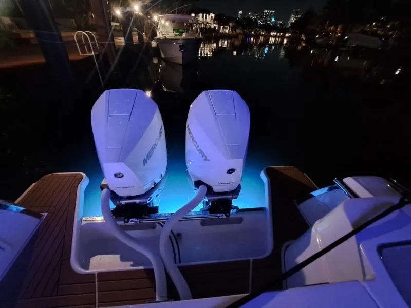 Slide: The Image of 2024 Southport 30 FE boat with dual Mercury engines illuminated at night. - 38