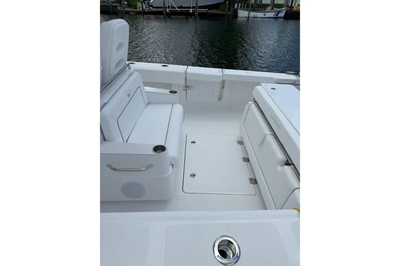 Slide: The Image of 2026 Southport 30 FE boat interior with white seating and storage compartments. - 4