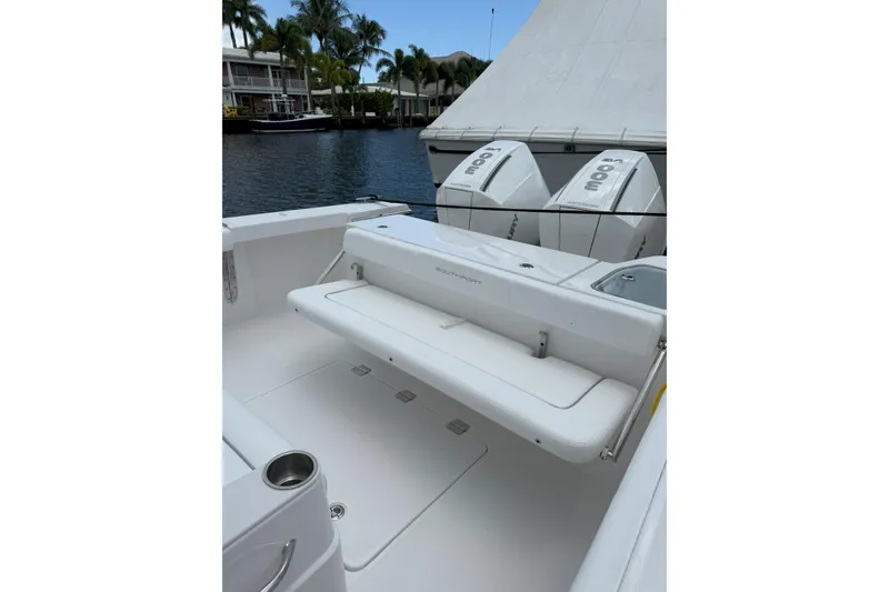 Slide: The Image of 2026 Southport 30 FE boat with dual Mercury engines, docked by waterfront homes. - 6