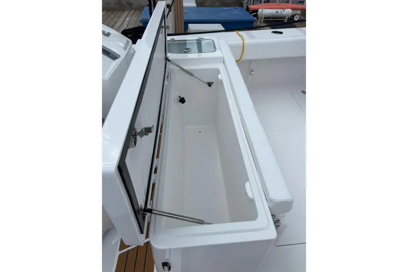 Slide: The Image of Open storage compartment on 2026 Southport 30 FE boat, showcasing spacious interior. - 8