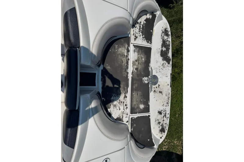 Slide: The Image of 2006 Yamaha Boats AR230 HO interior with worn seating and deck. - 11
