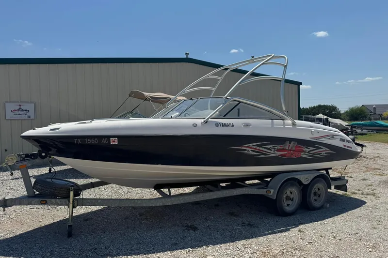 Slide: The Image of 2006 Yamaha Boats AR230 HO on trailer, parked outdoors under clear sky. - 3