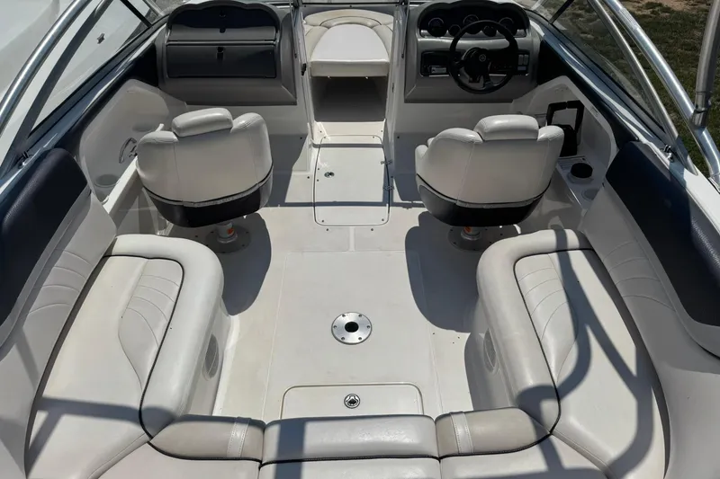 Slide: The Image of 2006 Yamaha Boats AR230 HO interior with white seating and steering console. - 6