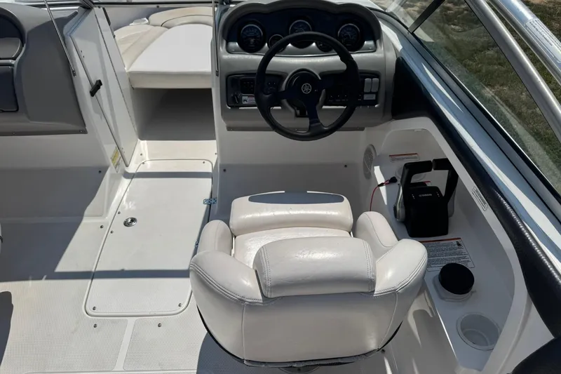 Slide: The Image of 2006 Yamaha Boats AR230 HO cockpit with steering wheel and white seating. - 7