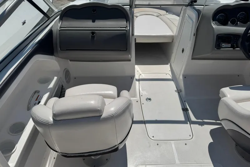 Slide: The Image of Interior of 2006 Yamaha Boats AR230 HO, featuring white seating and dashboard controls. - 9